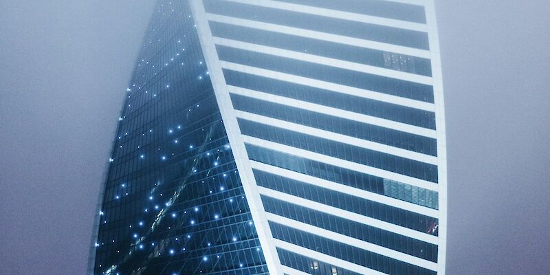 a very tall building in the middle of a foggy sky. Photo by Aleksandr Popov, Unsplash.